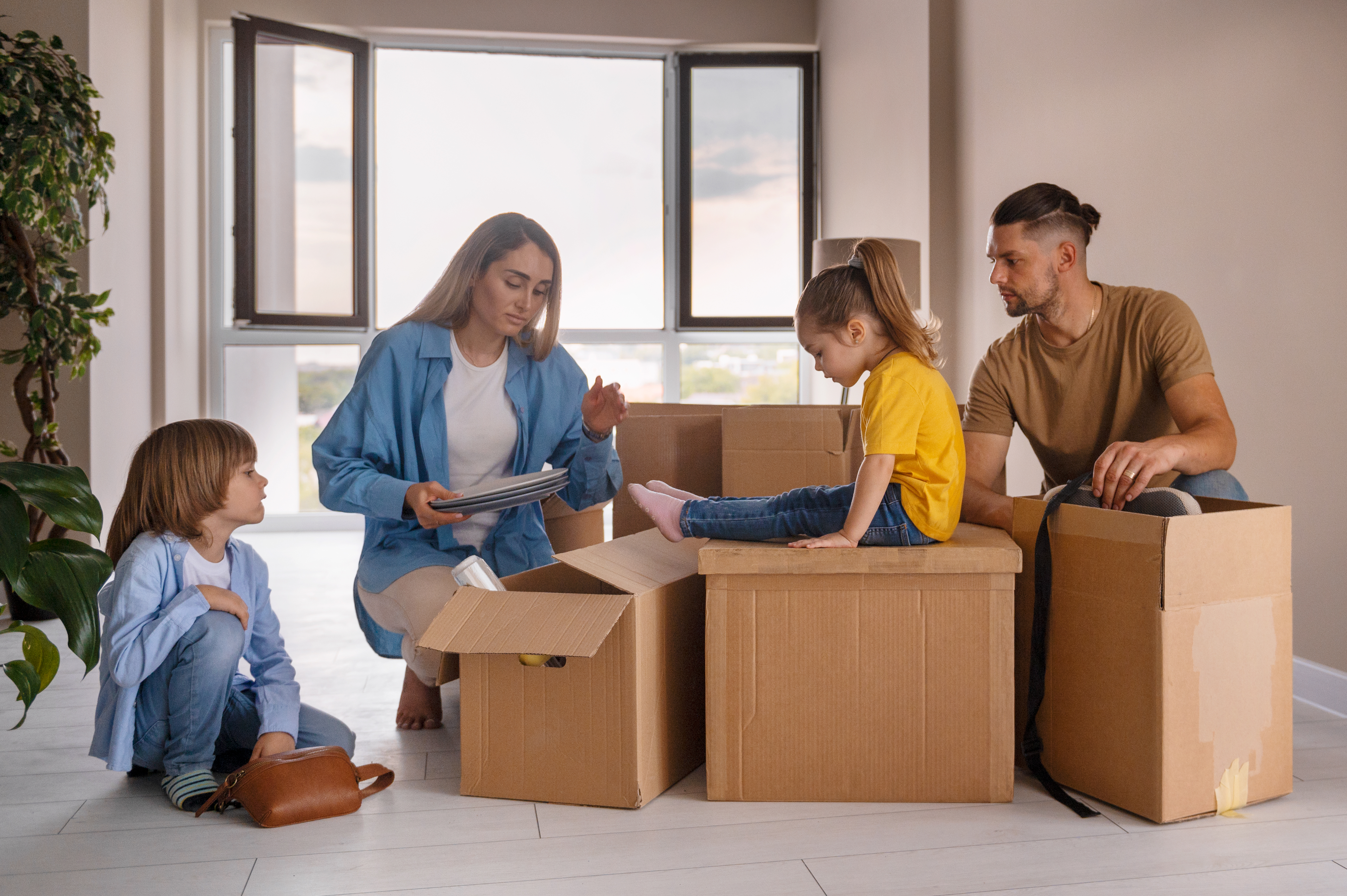 Military family loading belongings into a climate-controlled storage unit during PCS season